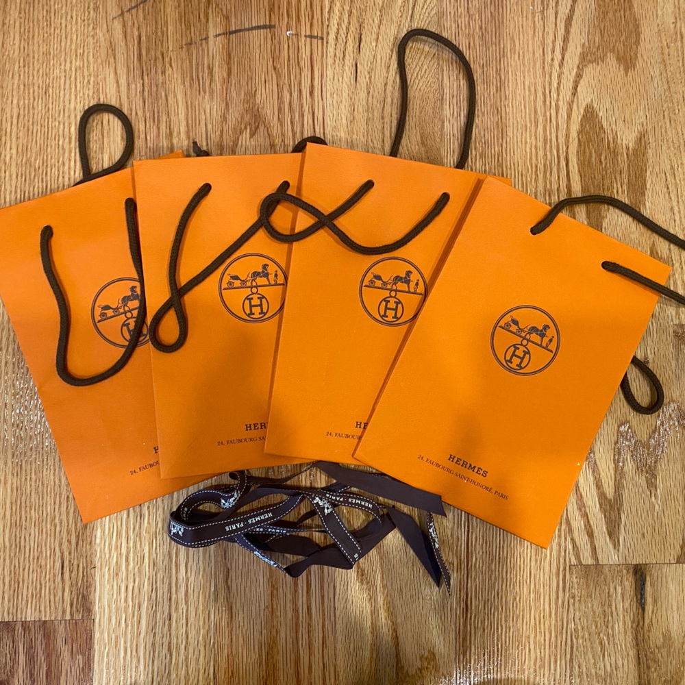 Four small Hermes paper bags